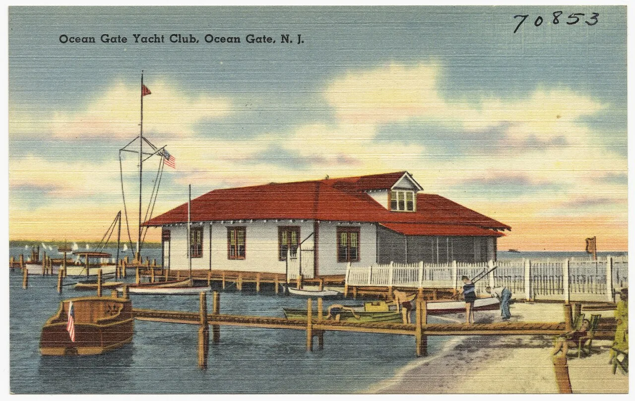 Vintage postcard of the Ocean Gate Yacht Club, a red-roofed clubhouse on the water with boats at the dock