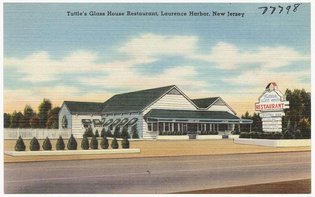 A vintage color postcard of Tuttle's Glass House restaurant beside a highway in Laurence Harbor