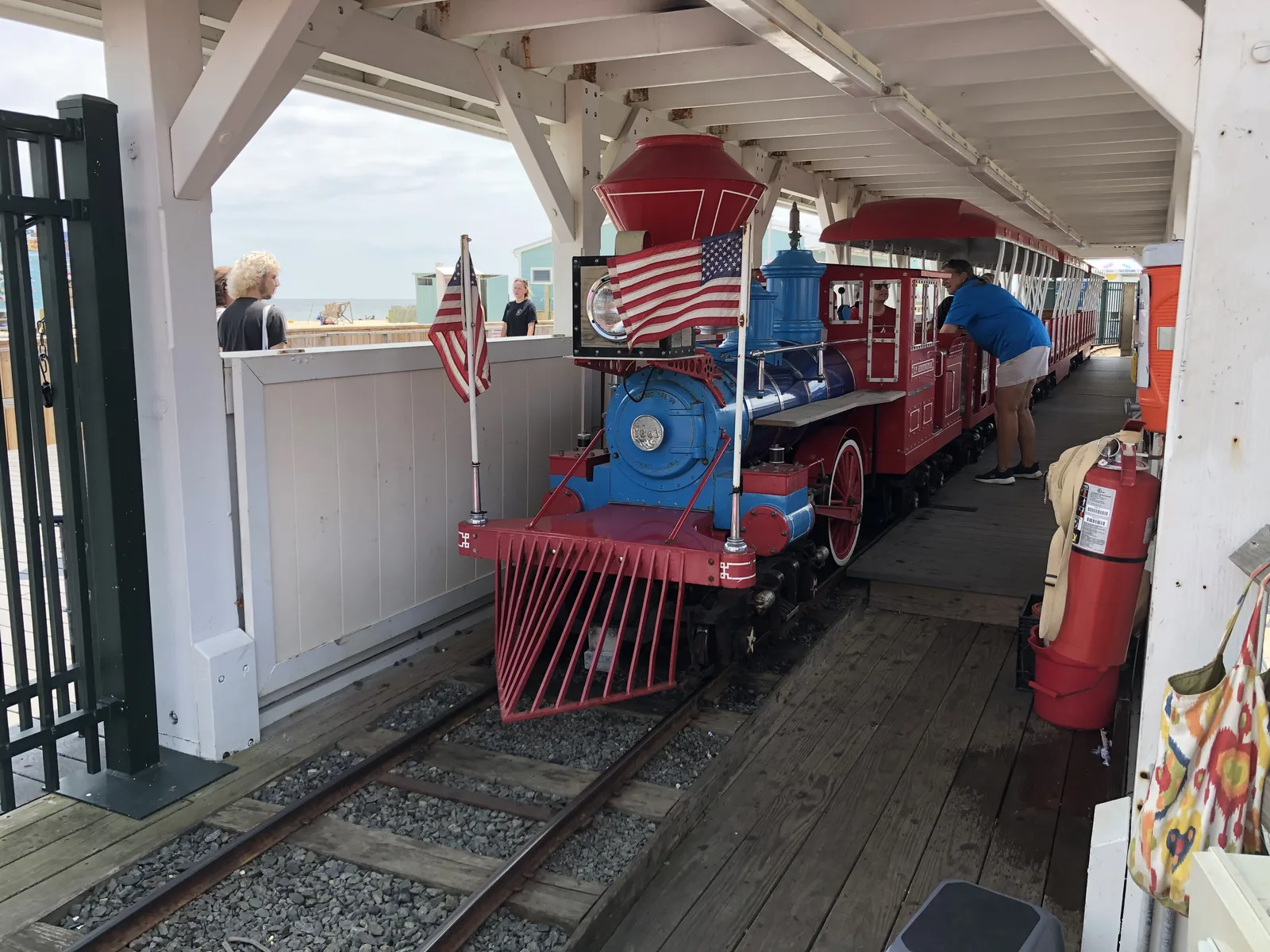 The small blue and red Jenkinson's Boardwalk train waiting in its station