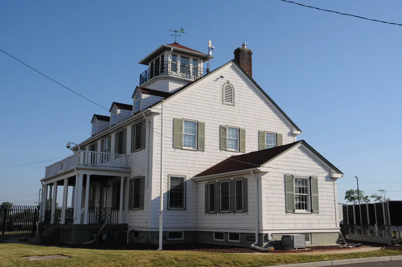 The white Colonial Revival Old Coast Guard Station at the Manasquan Inlet