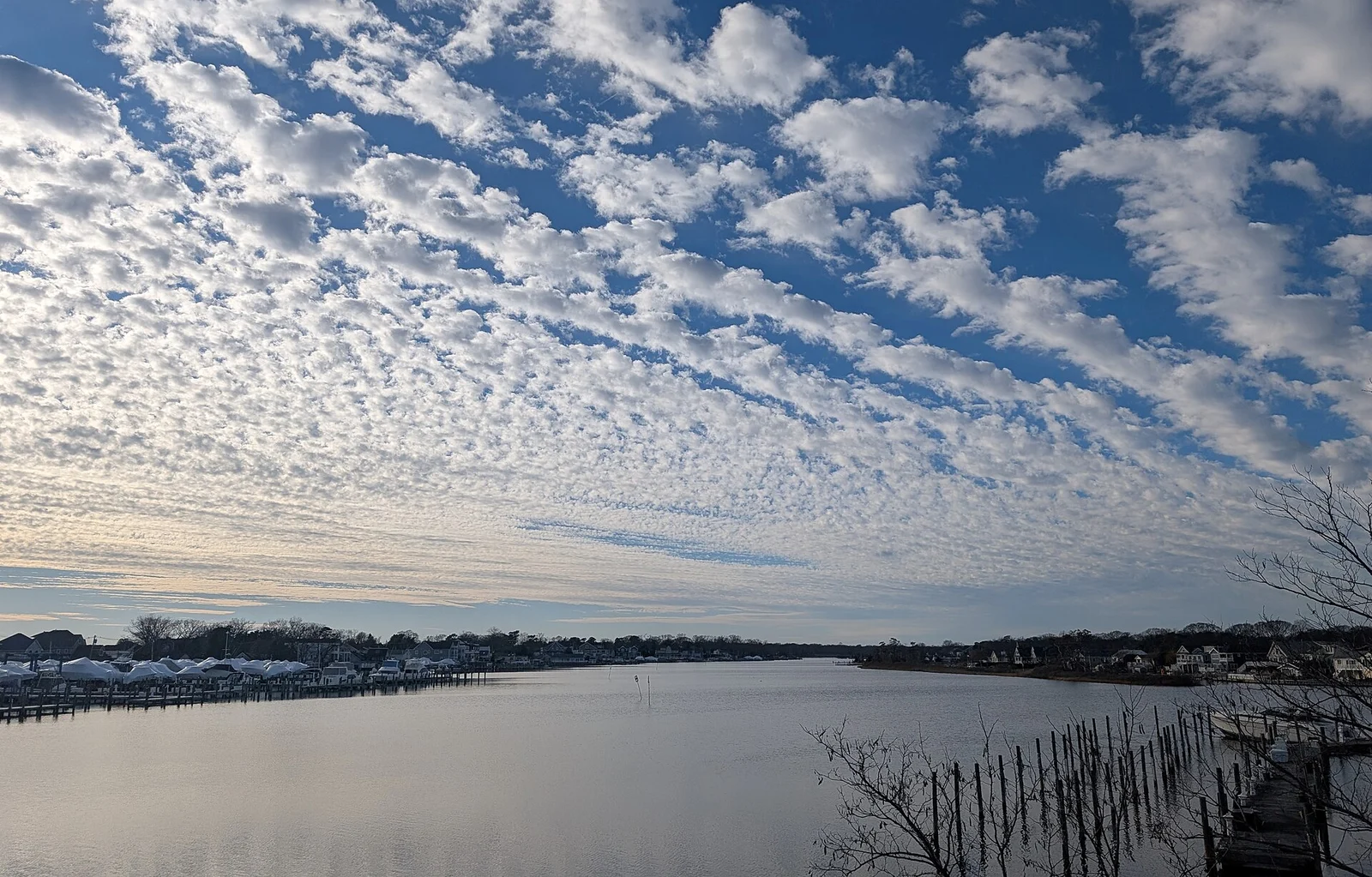Beaverdam Creek under a sky full of small white clouds, with docks and waterfront homes along the far shore