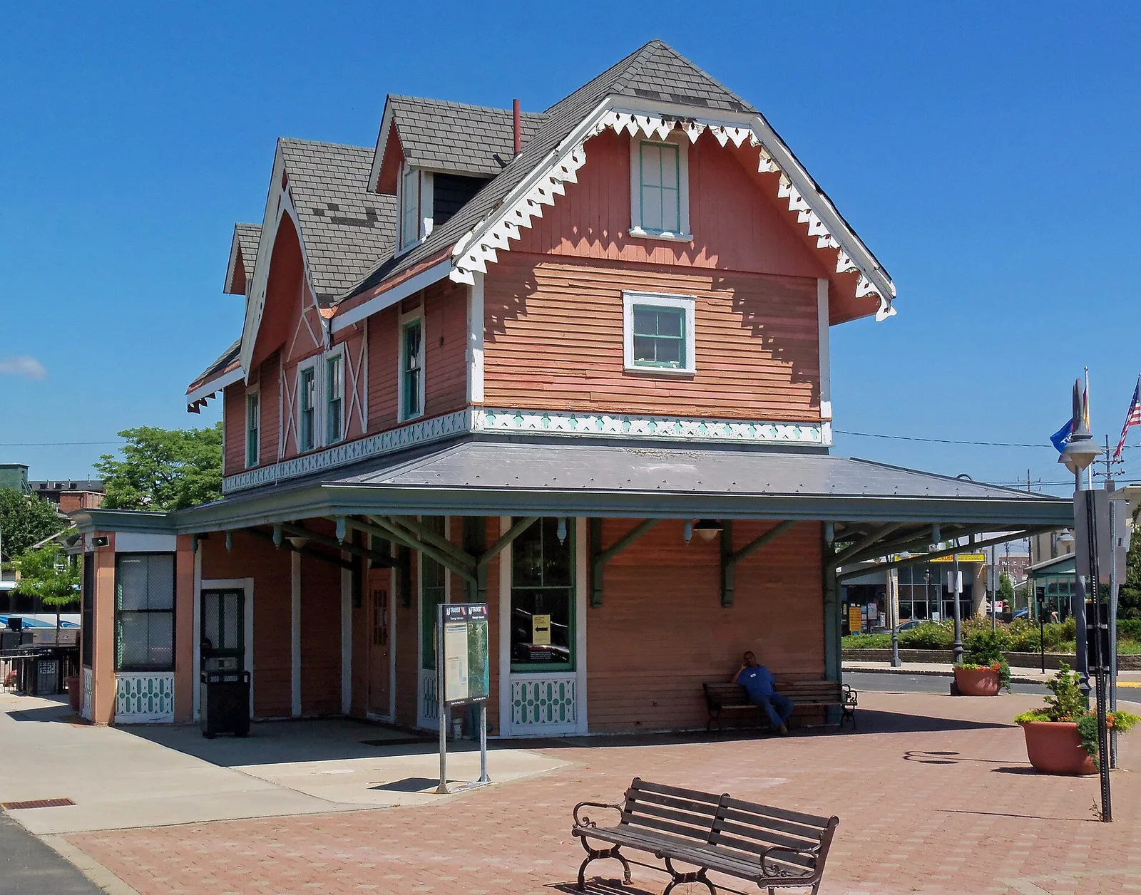 The restored Victorian Red Bank train station building with its steep gables and a brick plaza