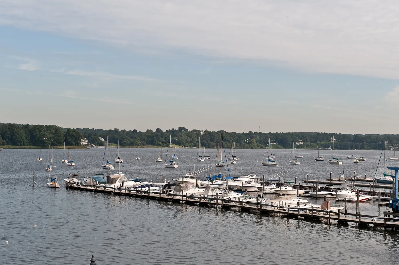 Boats docked along the Navesink River at Red Bank under a wide summer sky
