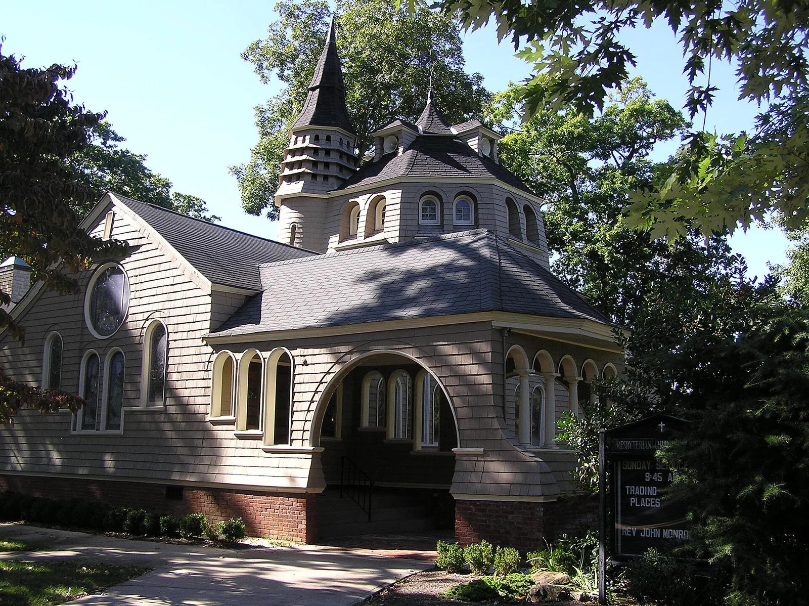 The shingled First Presbyterian Church of Rumson, with a pointed tower, an octagonal dome and an arched entry porch