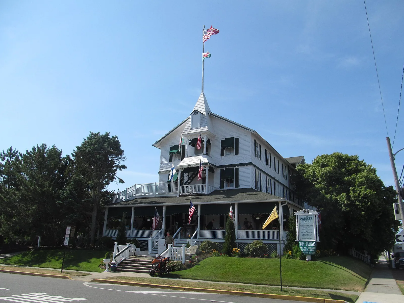 The Parker House in Sea Girt, a large white building with a wraparound porch and a flag-topped cupola