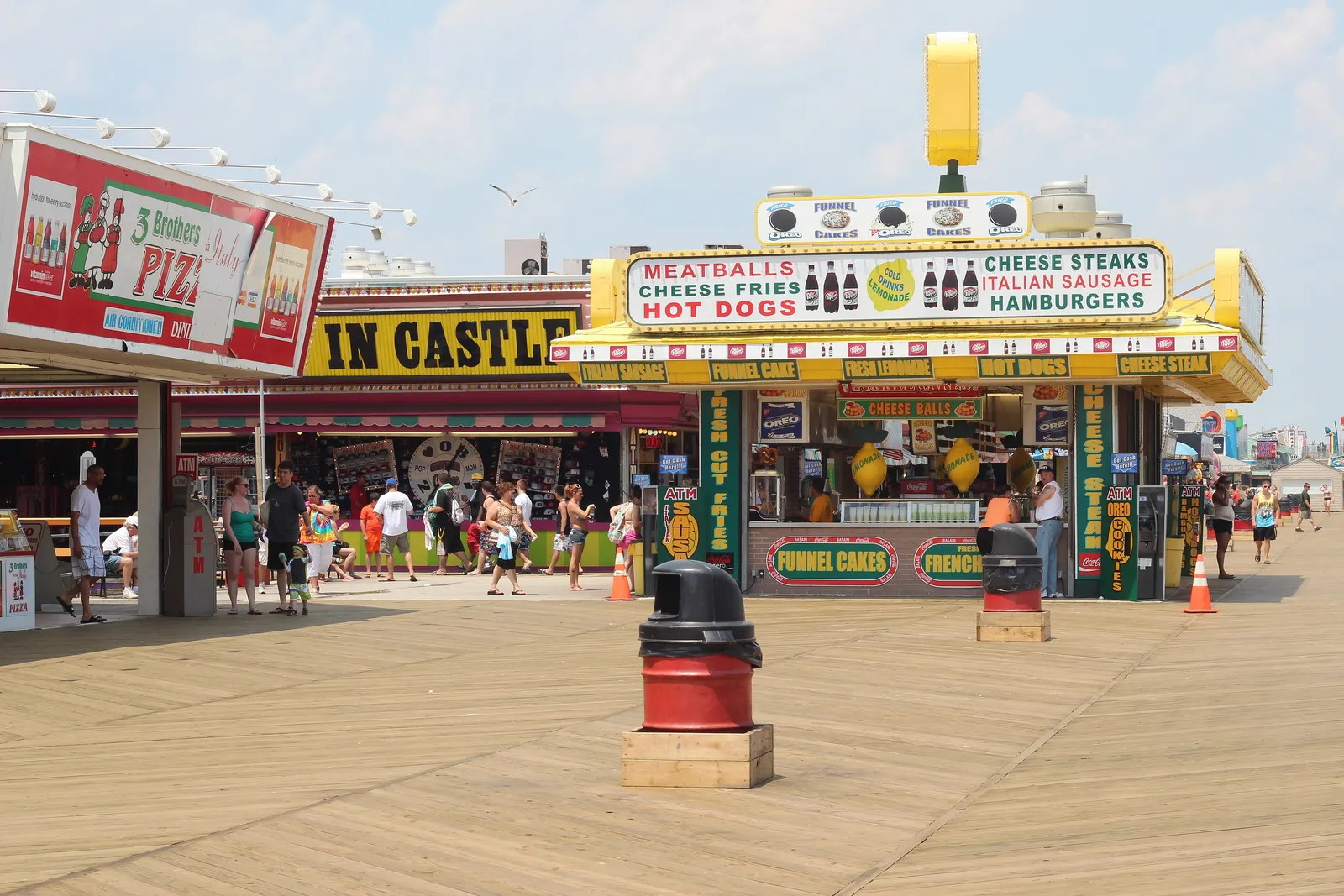 Food stands and shops along the boardwalk on a sunny day