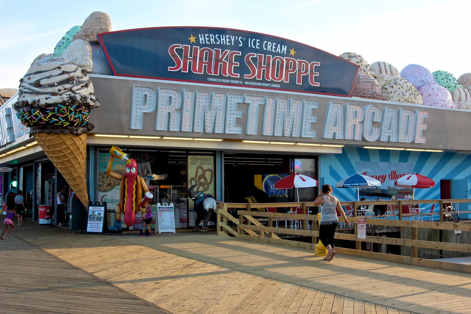 The Shake Shoppe and Primetime Arcade storefront with giant ice cream cone decorations on the boardwalk