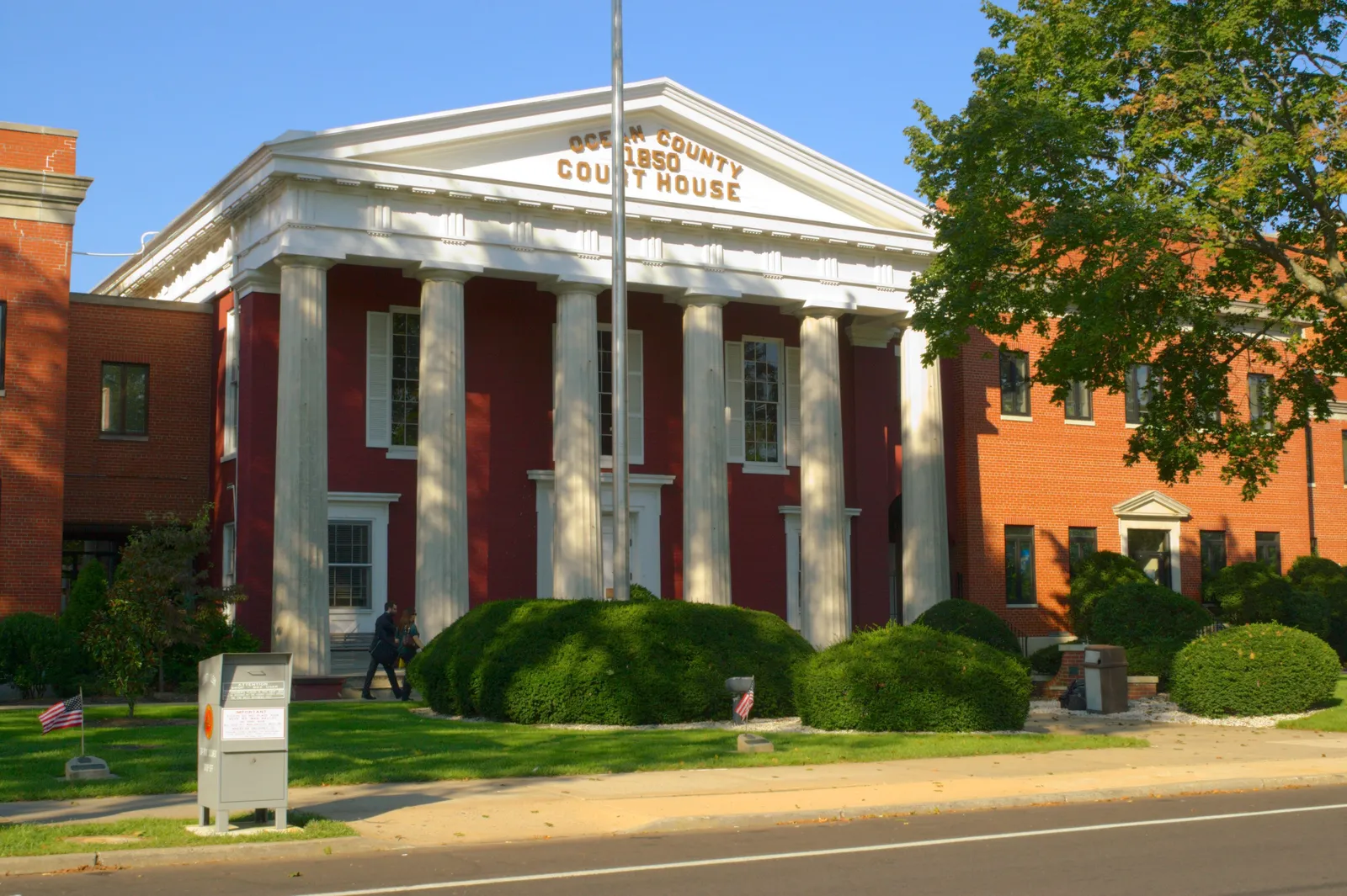 The Ocean County Courthouse, with white columns across a red front and a brick wing beside it