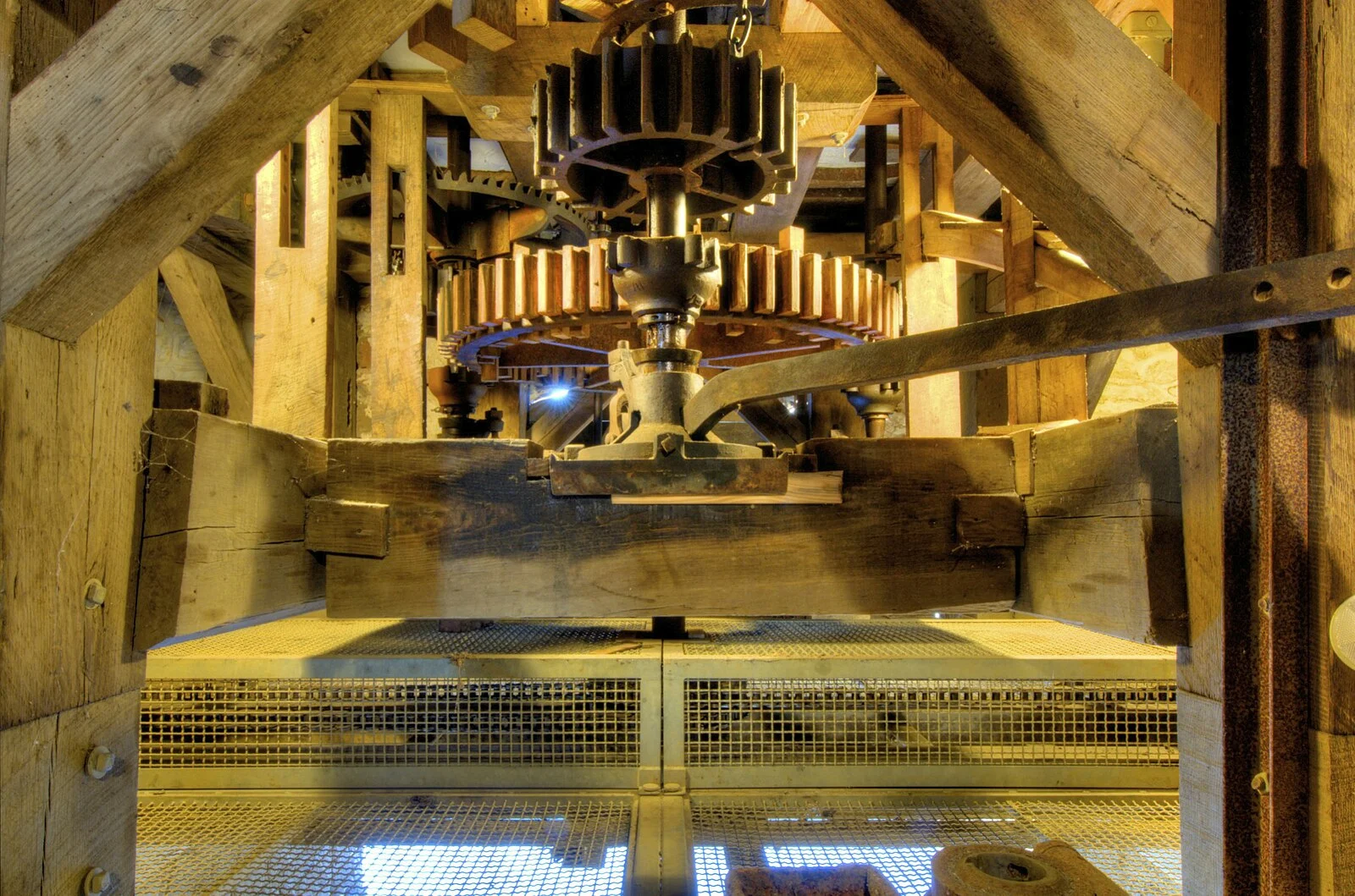 Wooden gears, shafts and the great spur wheel of the working gristmill machinery inside Waln's Mill