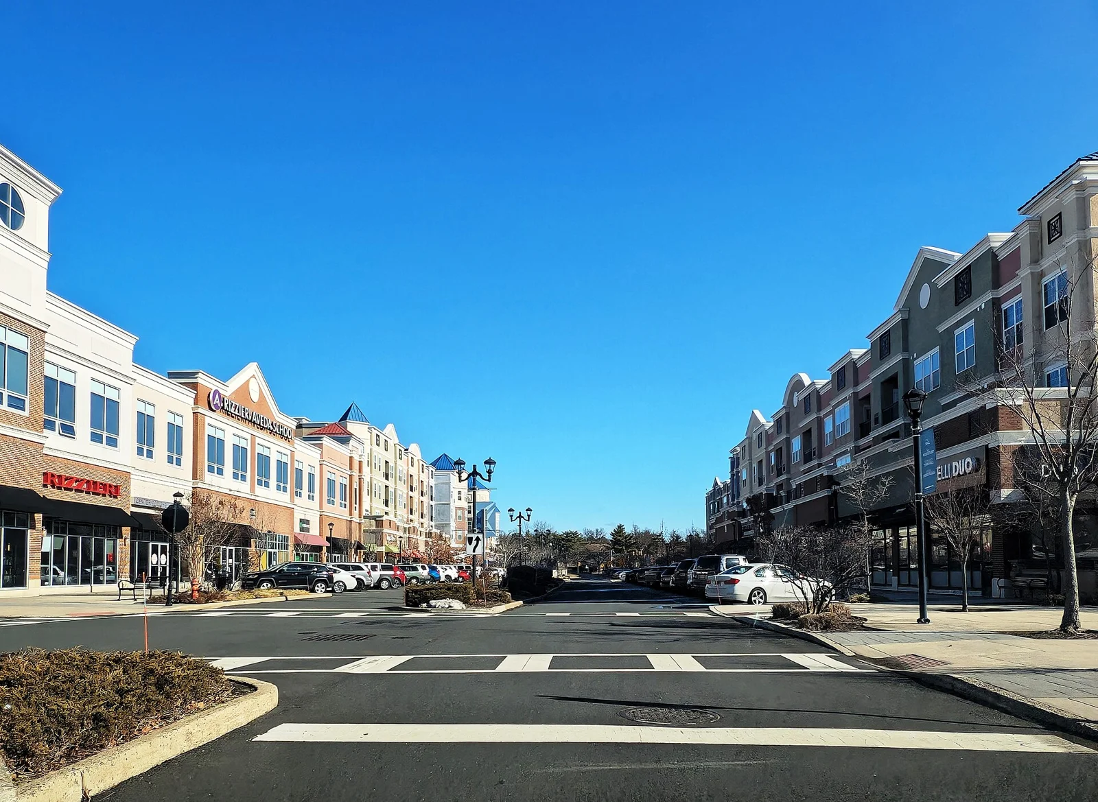 Shops with apartments above lining the Boulevard section of the Voorhees Town Center under a blue sky
