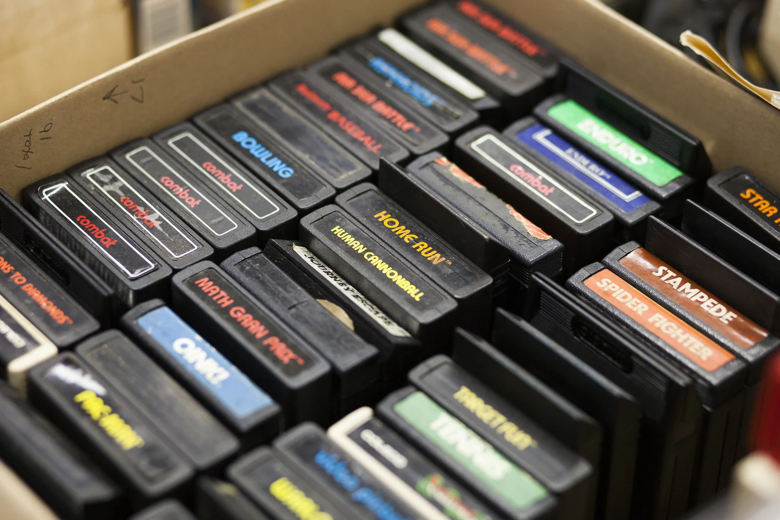 A box packed with vintage Atari video game cartridges at the Vintage Computer Festival East