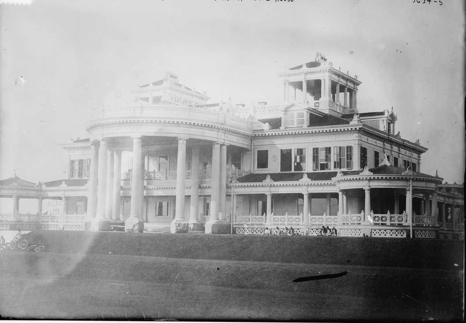 A black-and-white photo of the original Shadow Lawn mansion with its columned porches, early 1900s