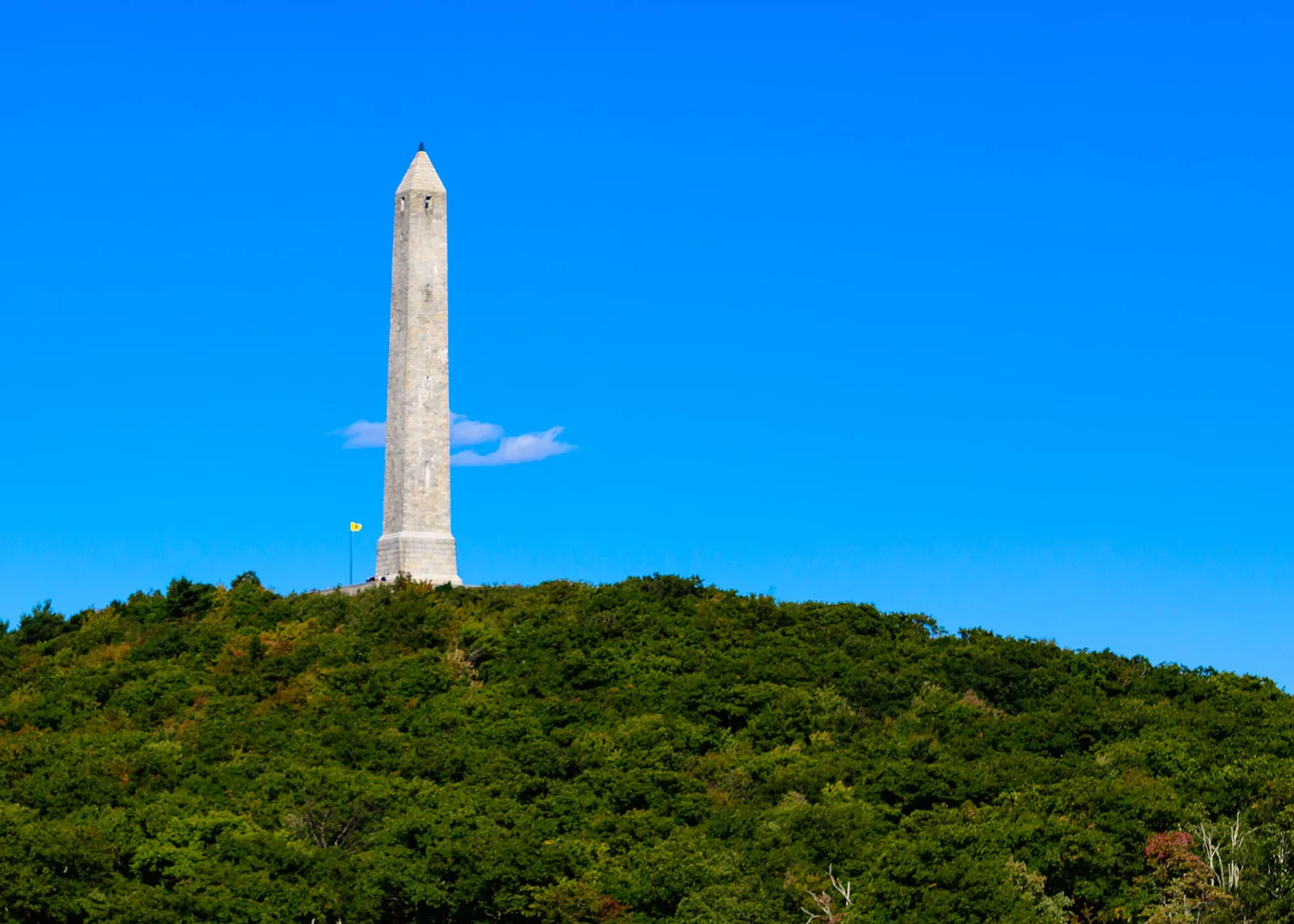 High Point Monument on its wooded summit under a blue sky, High Point State Park, New Jersey