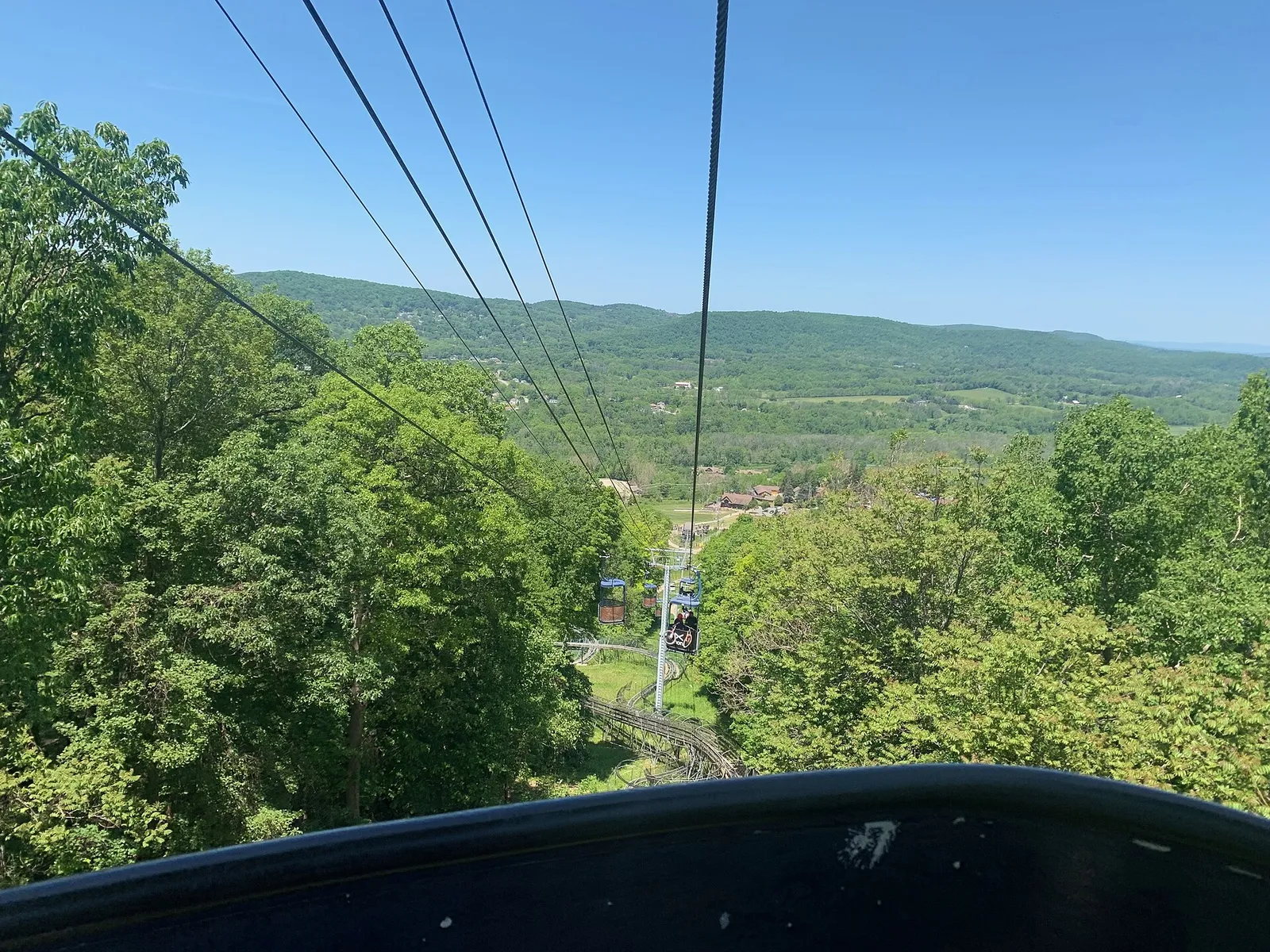 View from the summer chairlift over green mountain slopes at Mountain Creek