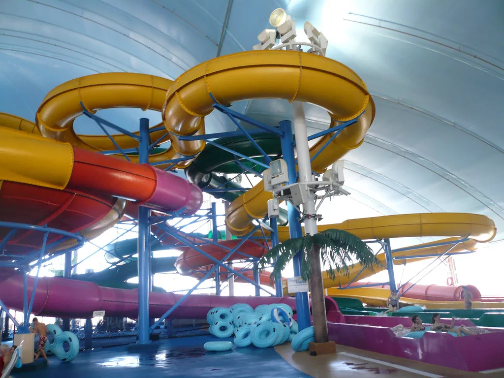 Colorful spiral water slides inside an indoor water park