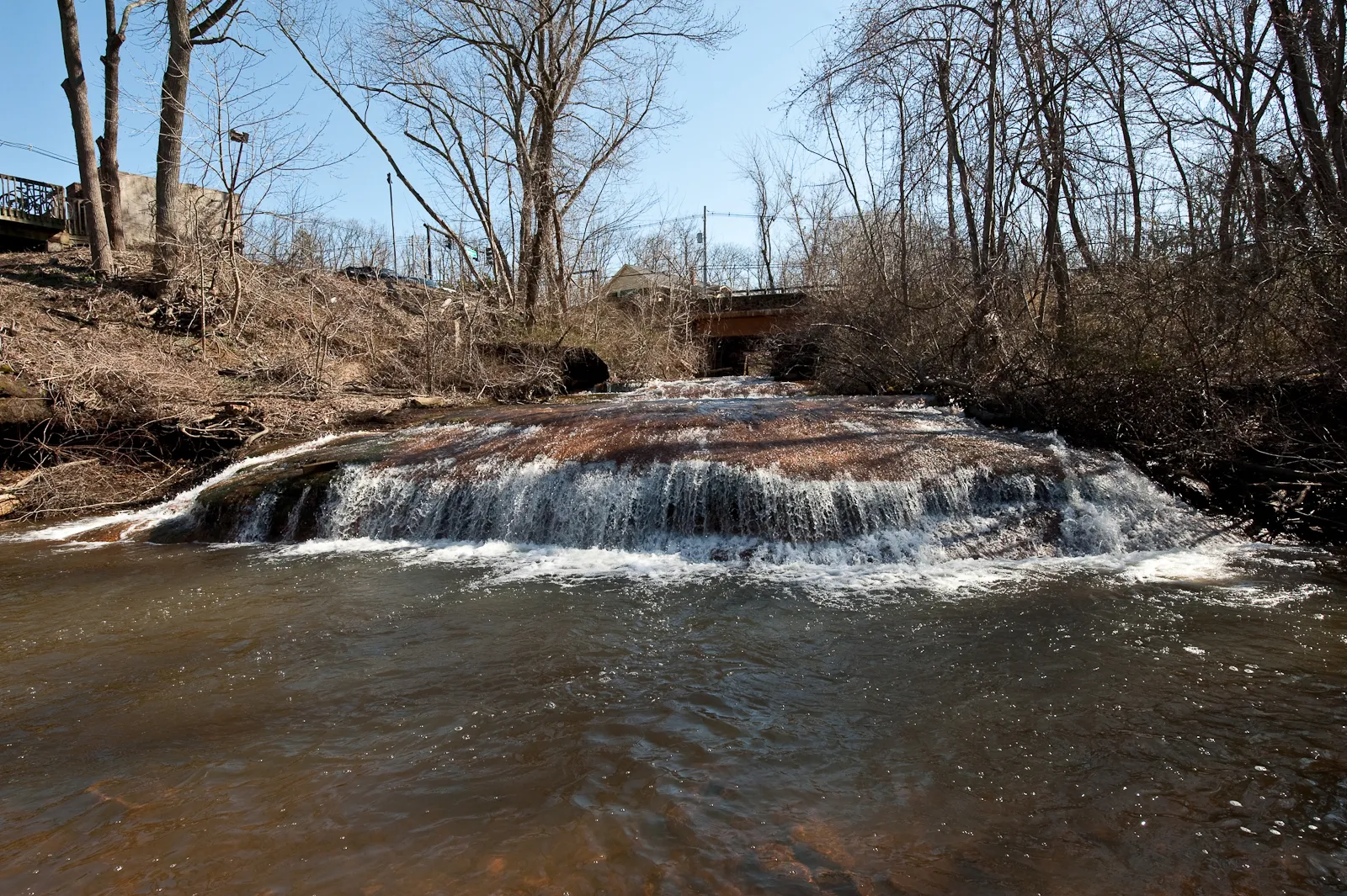 Water spilling over a wide low rock ledge at Tinton Falls