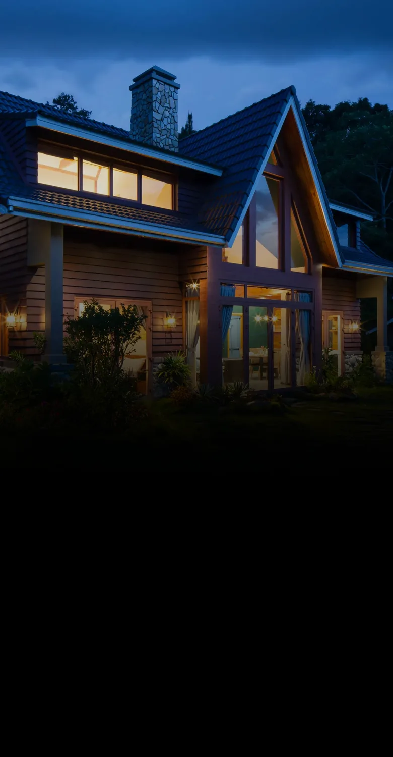 A home at dusk, fading into a fine-line drawing of a house parted down the middle