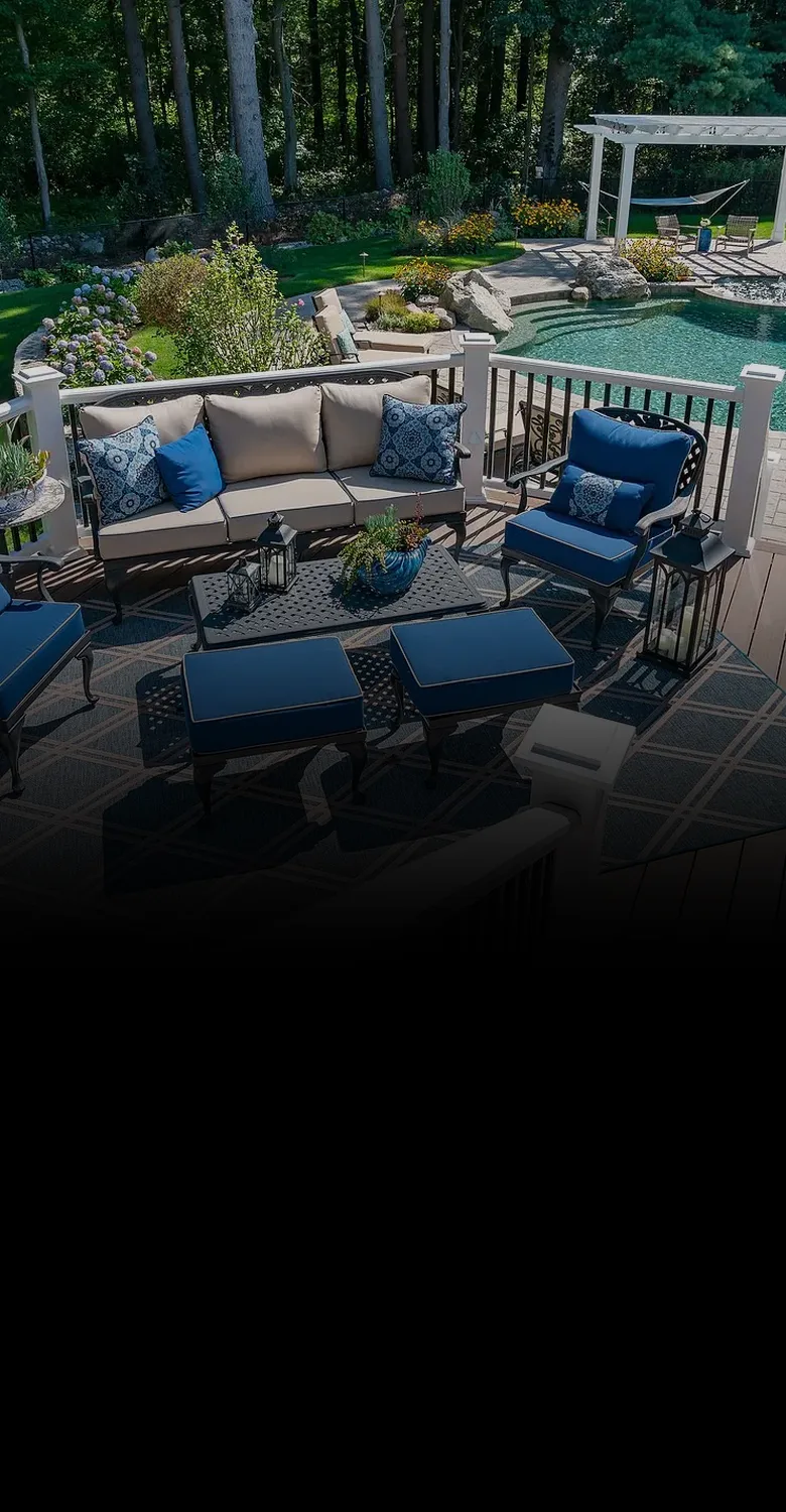 A deck with a pool and pergola, fading into a fine-line drawing of a smaller home and a larger one joined by a red arrow